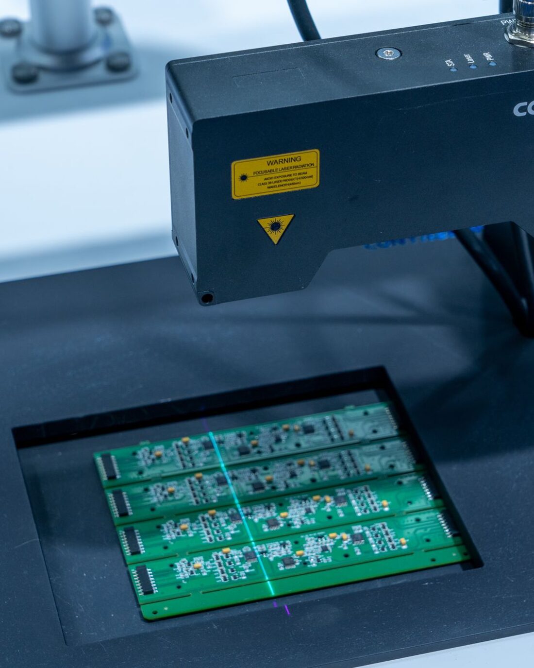 Automated optical inspection head scanning a panelised array of green printed circuit boards.
