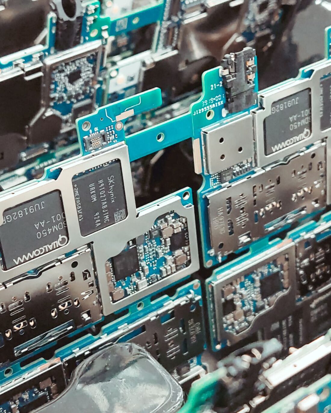 Populated circuit board panels stacked in a production tray after assembly.