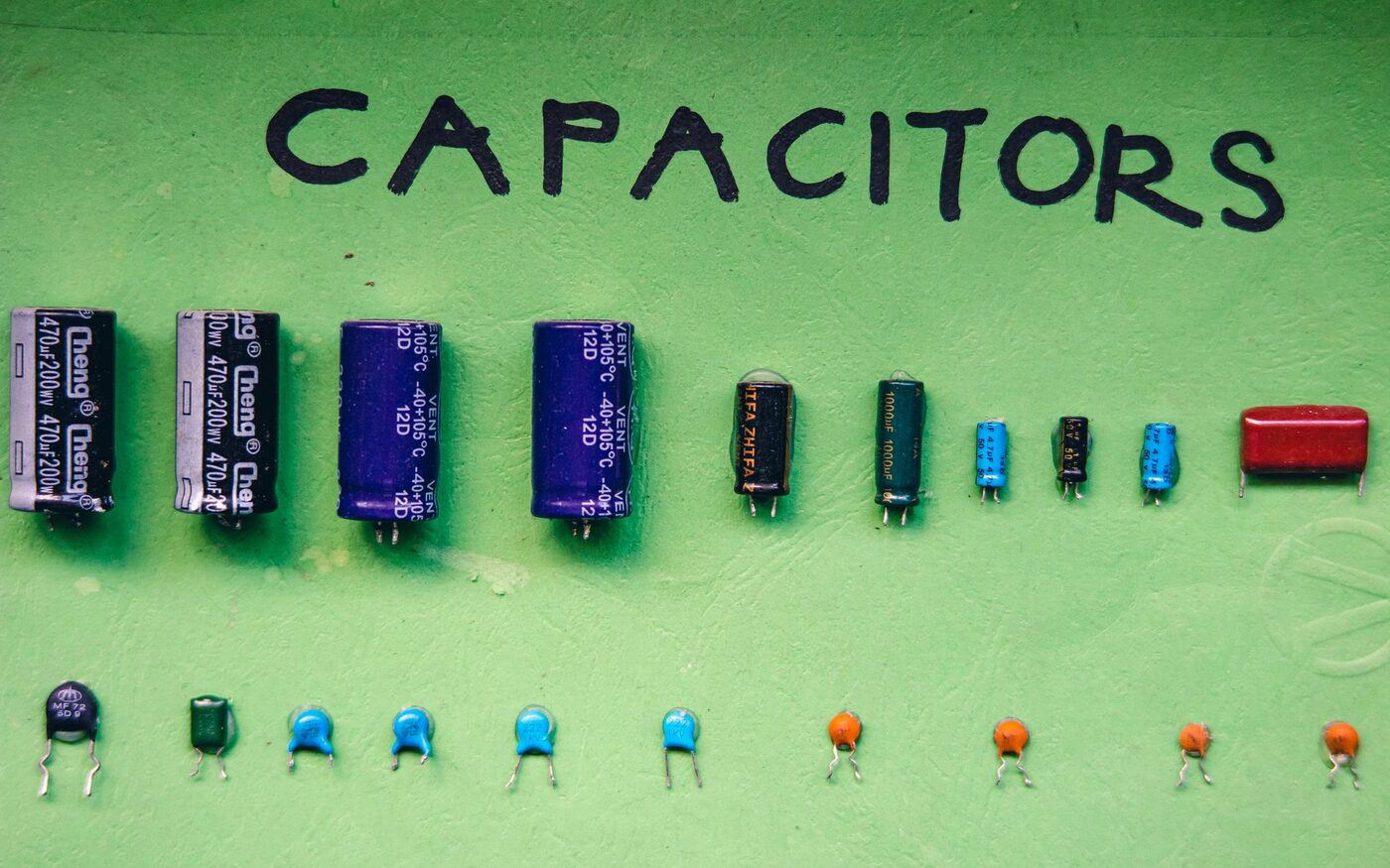 Reference board displaying a graded range of capacitors, from large electrolytics to small ceramics.