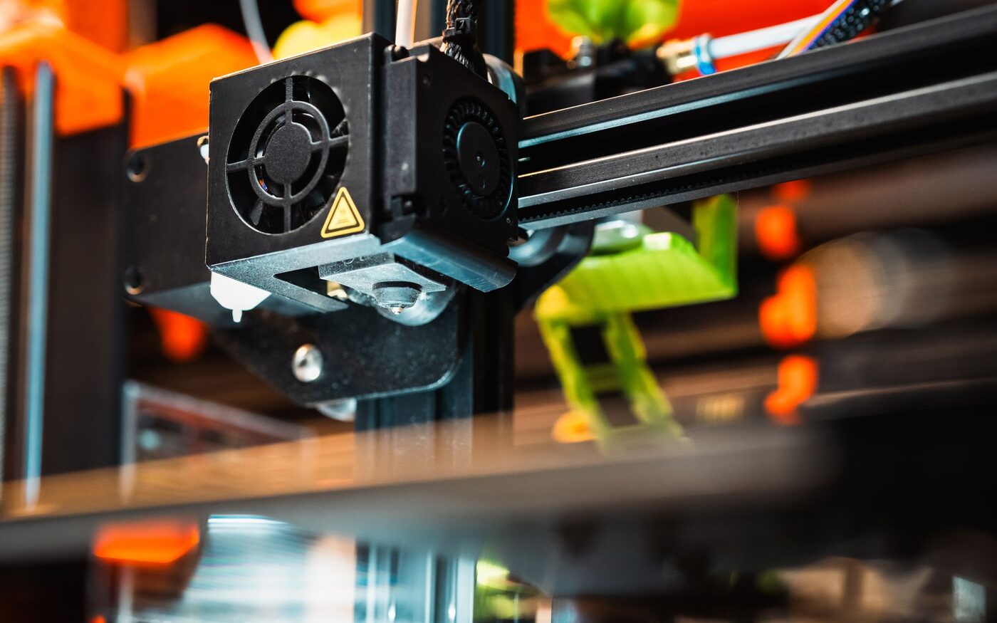FDM 3D printer extruding filament while building a plastic enclosure part.