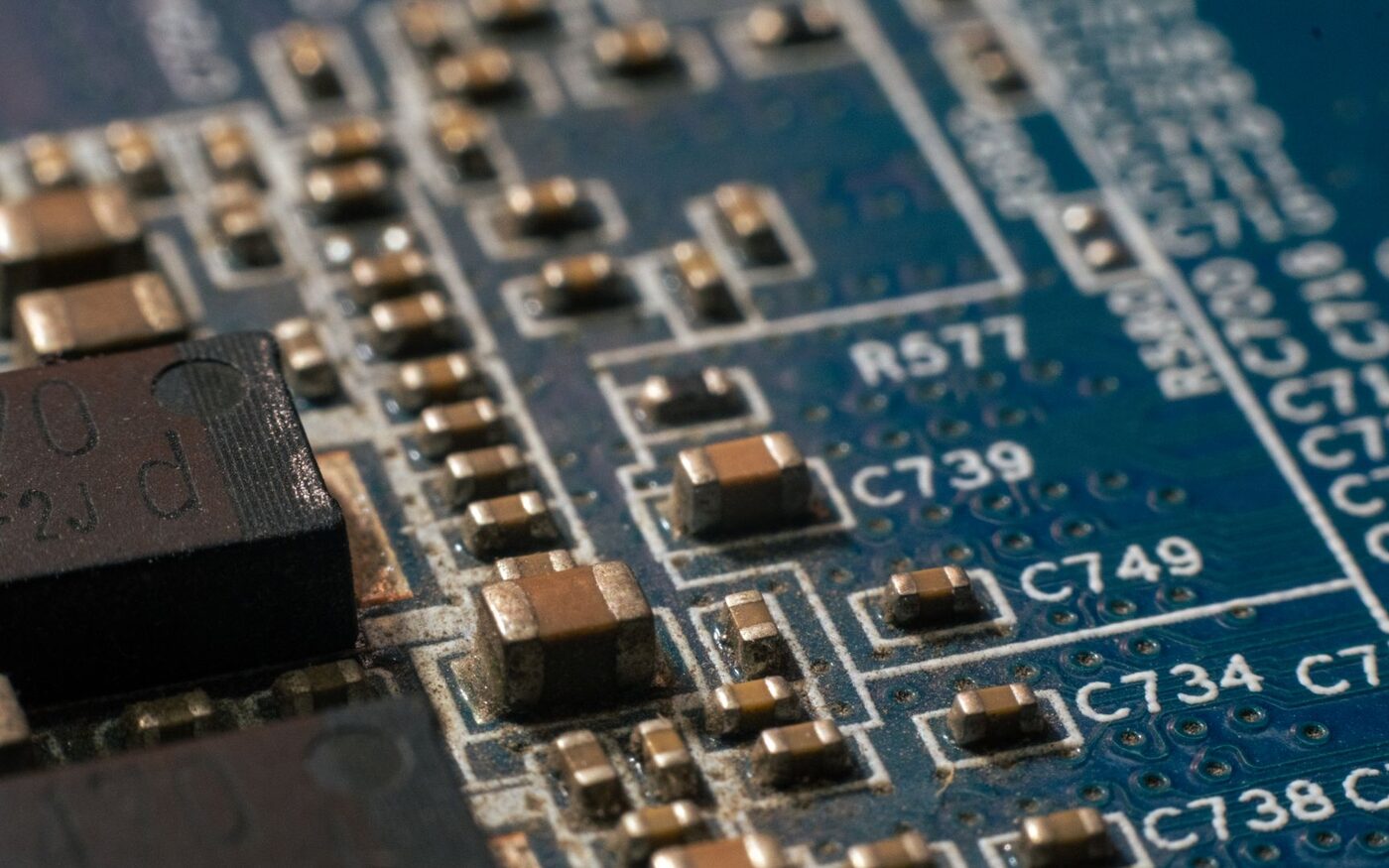 Macro view of a multilayer board showing copper surface-mount components and printed reference designators.