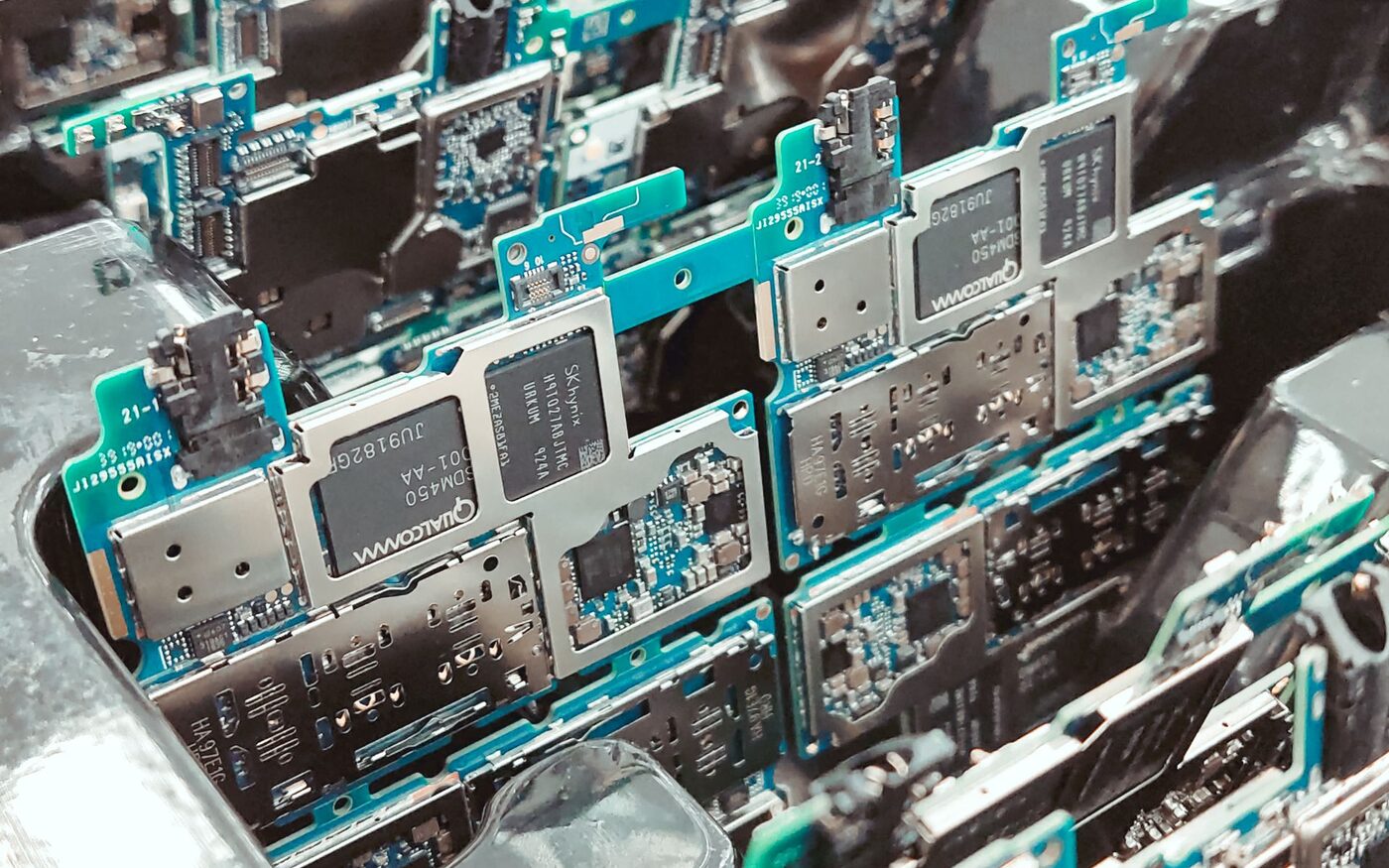 Populated circuit board panels stacked in a production tray after assembly.