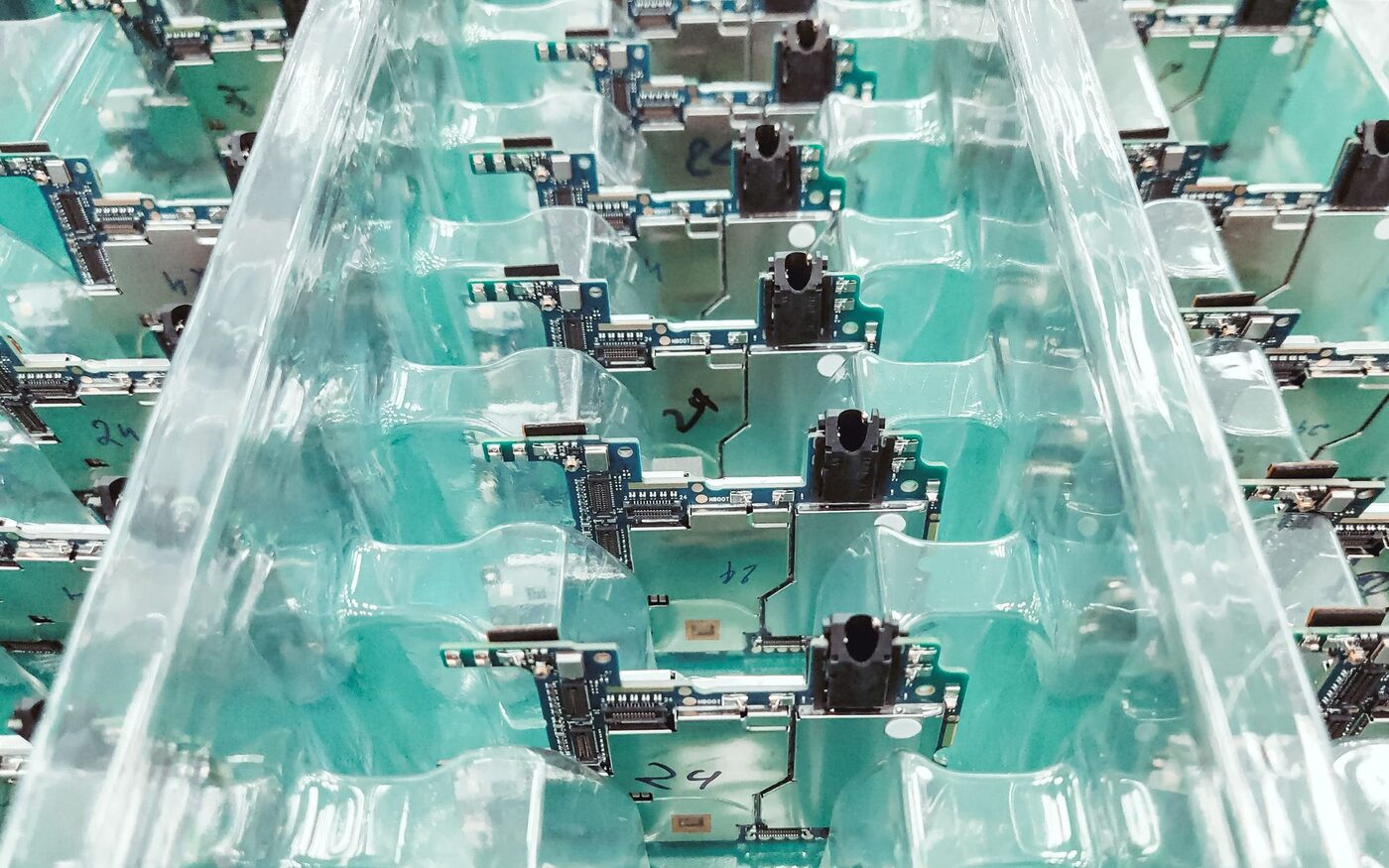 Finished circuit boards packed in moulded blister trays ready for despatch.